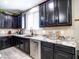 Modern kitchen features black cabinetry, stainless steel appliances, granite countertops, and decorative backsplash at 761 W Desert Hollow Dr, San Tan Valley, AZ 85143