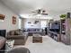 A cozy loft area featuring a comfortable sectional sofa, entertainment center, and natural light at 761 W Desert Hollow Dr, San Tan Valley, AZ 85143