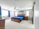 Bright main bedroom features a king-size bed, ceiling fan, and barn door leading to the en-suite bathroom at 761 W Desert Hollow Dr, San Tan Valley, AZ 85143