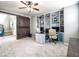 Home office with custom built-ins, dual workstations, and a modern ceiling fan at 761 W Desert Hollow Dr, San Tan Valley, AZ 85143