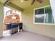 Relaxing covered patio with modern grills and a ceiling fan, perfect for outdoor cooking at 761 W Desert Hollow Dr, San Tan Valley, AZ 85143