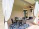 Inviting covered patio with stylish seating, ceiling fan and elegant curtains for relaxed entertaining at 761 W Desert Hollow Dr, San Tan Valley, AZ 85143