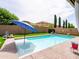 Private backyard pool with well-manicured landscaping, surrounded by privacy fence at 761 W Desert Hollow Dr, San Tan Valley, AZ 85143