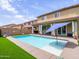 Backyard pool with an open-air cabana and artificial turf in a cozy outdoor space at 761 W Desert Hollow Dr, San Tan Valley, AZ 85143