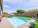 Refreshing pool with a sun umbrella and a hammock in a private backyard at 761 W Desert Hollow Dr, San Tan Valley, AZ 85143
