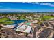 Aerial view showcases community amenities: pool, lake, golf course, and clubhouse at 7707 E Park View Dr, Mesa, AZ 85208