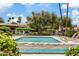 Inviting community pool surrounded by lush landscaping and comfortable lounge chairs at 7707 E Park View Dr, Mesa, AZ 85208