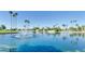 Scenic lake with a fountain surrounded by palm trees and lush greenery at 7707 E Park View Dr, Mesa, AZ 85208