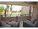 Relaxing covered balcony featuring comfortable seating and a serene view of the green golf course at 7777 E Main St # 227, Scottsdale, AZ 85251