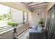 Inviting covered balcony area with comfortable seating, charming string lights, and lush green landscape views at 7777 E Main St # 227, Scottsdale, AZ 85251