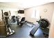 This home gym features a mirror, television, elliptical machine, and recumbent bike at 7777 E Main St # 227, Scottsdale, AZ 85251