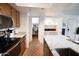 A modern kitchen features stainless steel appliances, granite countertops, and a view into storage and laundry areas at 7777 E Main St # 227, Scottsdale, AZ 85251