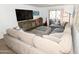 Spacious living room with a large sectional sofa, guitar, and a balcony with sliding glass doors for outdoor enjoyment at 7777 E Main St # 227, Scottsdale, AZ 85251