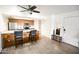 A spacious living space flows into a kitchen area featuring a breakfast bar with seating and modern appliances at 7777 E Main St # 227, Scottsdale, AZ 85251