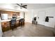 A spacious living space flows into a kitchen area featuring a breakfast bar with seating and modern appliances at 7777 E Main St # 227, Scottsdale, AZ 85251
