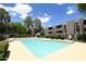 Sparkling community pool with clear blue water, surrounded by lush greenery and lounge seating at 7777 E Main St # 227, Scottsdale, AZ 85251