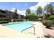 Refreshing community pool area with lush landscaping, lounge chairs, and umbrella shaded tables at 7777 E Main St # 227, Scottsdale, AZ 85251