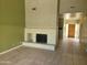 Spacious living room featuring a fireplace and tile flooring, leading to the front door at 7914 E Bonita Dr, Scottsdale, AZ 85250