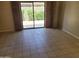 Open living room featuring tile flooring and sliding glass doors to the exterior at 7914 E Bonita Dr, Scottsdale, AZ 85250