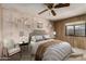 Inviting bedroom with wood paneled walls, a bed, and decorative elements at 8103 E Southern Ave # 119, Mesa, AZ 85209