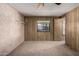 Bright bedroom featuring wood paneling, neutral carpet, and a ceiling fan at 8103 E Southern Ave # 119, Mesa, AZ 85209