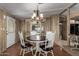 Dining area features hardwood floors, a vintage chandelier, and a built-in display cabinet at 8103 E Southern Ave # 119, Mesa, AZ 85209