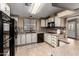Well-lit kitchen featuring white cabinets, tile backsplash, and black appliances at 8103 E Southern Ave # 119, Mesa, AZ 85209