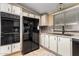 The kitchen features black appliances, white cabinets, and decorative tile backsplash at 8103 E Southern Ave # 119, Mesa, AZ 85209