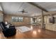 Cozy living room with hardwood flooring, complemented by a stylish ceiling fan and wood-paneled walls at 8103 E Southern Ave # 119, Mesa, AZ 85209