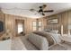 Comfortable main bedroom featuring a ceiling fan, wood paneled walls, and a window at 8103 E Southern Ave # 119, Mesa, AZ 85209