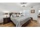 This is a well-lit bedroom with tiled floors, a ceiling fan, and minimalist decor at 8787 E Mountain View Rd # 1100, Scottsdale, AZ 85258