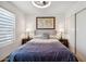 This is a bedroom with tiled floors, a ceiling fan, and a decorative map on the wall at 8787 E Mountain View Rd # 1100, Scottsdale, AZ 85258