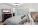The bedroom has tiled floors, a ceiling fan, a closet, and a TV on a dresser at 8787 E Mountain View Rd # 1100, Scottsdale, AZ 85258