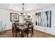 An open concept Dining Room featuring a dark wood table and decorative light fixture at 8787 E Mountain View Rd # 1100, Scottsdale, AZ 85258