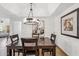 Inviting dining area with wood table, chairs, and modern chandelier, perfect for Gathering meals and gatherings at 8787 E Mountain View Rd # 1100, Scottsdale, AZ 85258
