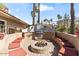 Outdoor firepit with built-in seating and grill, perfect for entertaining at 8787 E Mountain View Rd # 1100, Scottsdale, AZ 85258