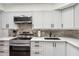 Well-equipped kitchen with modern appliances, stone backsplash, and plenty of counter space at 8787 E Mountain View Rd # 1100, Scottsdale, AZ 85258