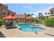 Community swimming pool with lounge seating and lush tropical surroundings at 8787 E Mountain View Rd # 1100, Scottsdale, AZ 85258
