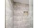 This is a tiled shower with a built-in tiled shelf in the corner at 8787 E Mountain View Rd # 1100, Scottsdale, AZ 85258