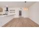 Bright dining room with modern wood floors and an elegant light fixture at 9414 N 50Th Dr, Glendale, AZ 85302