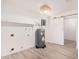 Bright utility room featuring an electric water heater, white walls, and light vinyl wood flooring at 9414 N 50Th Dr, Glendale, AZ 85302