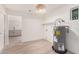 Bright utility room featuring an electric water heater, white walls, and light vinyl wood flooring at 9414 N 50Th Dr, Glendale, AZ 85302