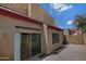 View of the backyard, enclosed by block wall, features gravel and a sliding door into the home at 1015 S Val Vista Dr # 52, Mesa, AZ 85204
