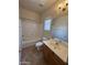 The bathroom has a ceramic tile floor, a modern vanity and a shower with tub at 1015 S Val Vista Dr # 52, Mesa, AZ 85204