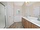 Bathroom features a double sink vanity, a window, and a shower/tub combo with a glass door and tile flooring at 1015 S Val Vista Dr # 52, Mesa, AZ 85204