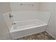 Close up of a white bathtub with tile flooring and silver faucet at 1015 S Val Vista Dr # 52, Mesa, AZ 85204