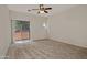 A spacious bedroom with carpet, ceiling fan, a sliding glass door leading to a balcony and natural light at 1015 S Val Vista Dr # 52, Mesa, AZ 85204