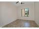 A cozy bedroom featuring a large window and neutral tile flooring at 1015 S Val Vista Dr # 52, Mesa, AZ 85204