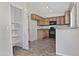 Bright kitchen with wood cabinets, black appliances, tile floors, and walk-in pantry at 1015 S Val Vista Dr # 52, Mesa, AZ 85204
