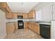 Well-lit kitchen featuring wood cabinets, tile flooring, and modern black appliances at 1015 S Val Vista Dr # 52, Mesa, AZ 85204